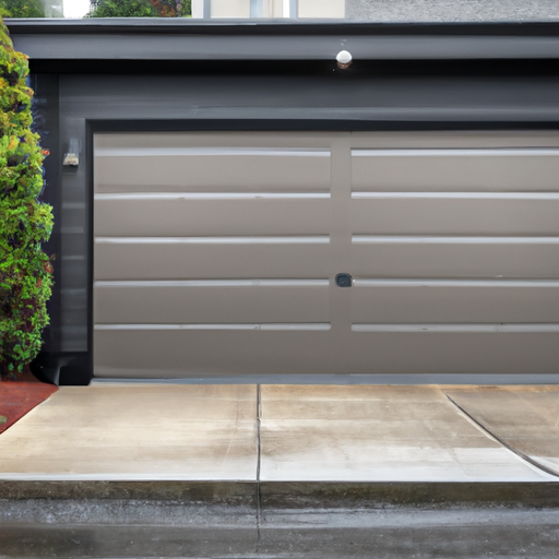 Closed insulated townhouse garage door in Tacoma on a wet, overcast day with evergreen background.